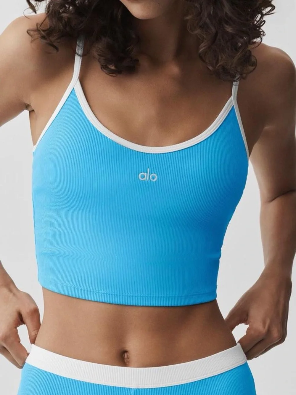ALO Women’s Goddess Ribbed First Pick Bra Tank in Azure Blue with White Trim.
